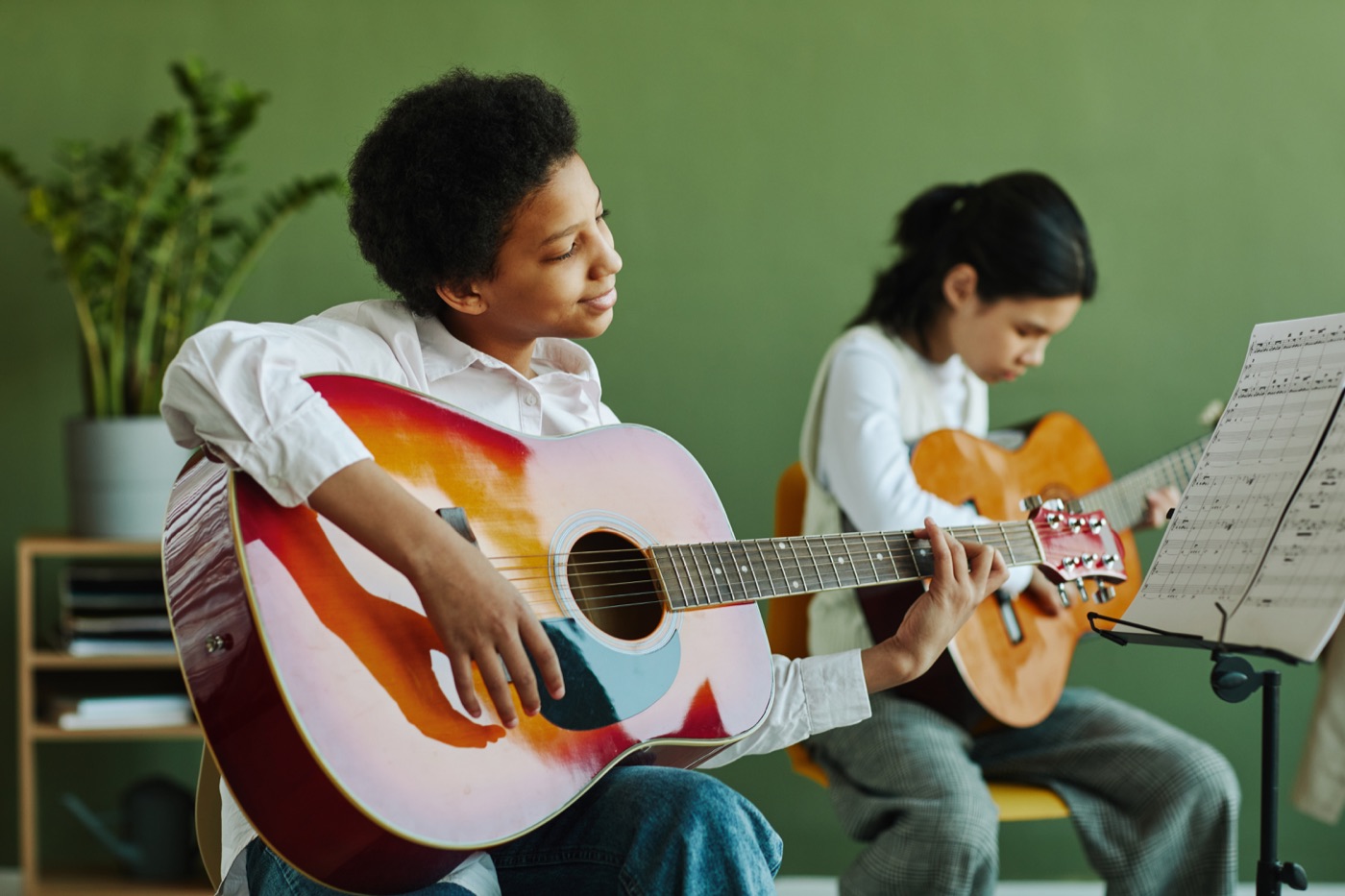 Two musicians playing guitar together